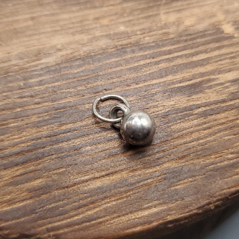 P110 silver tone ball pendant
